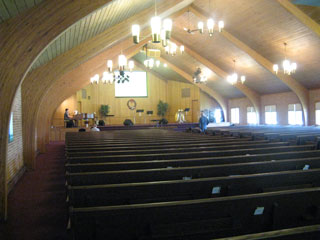 The auditorium. Behind the screen is the cross.
